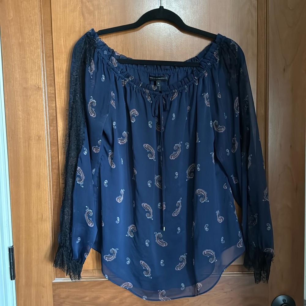 Navy blue blouse, sheer sleeves with black lace accent, body is lined